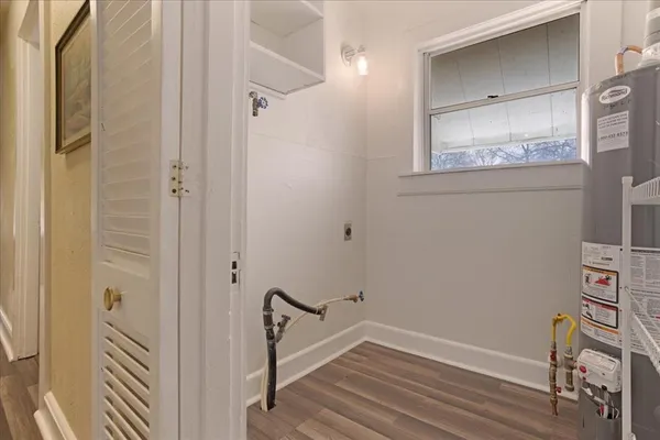 a view of a hallway with wooden floor and closet
