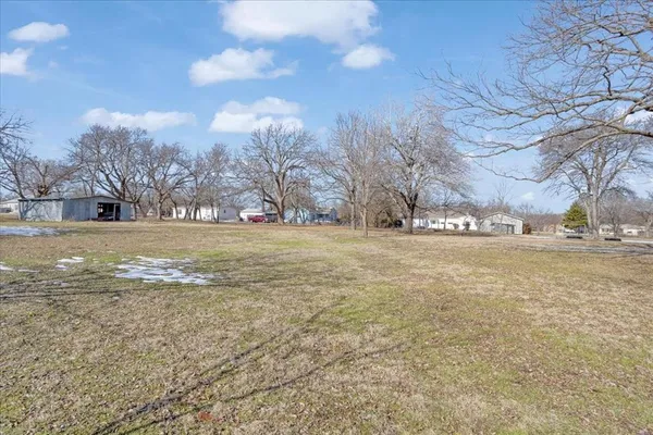 a view of a field with an trees