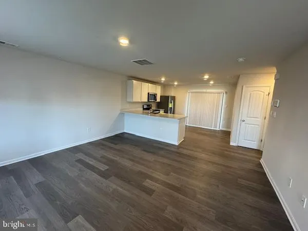 a kitchen with stainless steel appliances a refrigerator stove microwave and sink