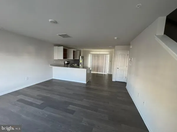 a kitchen with stainless steel appliances granite countertop a refrigerator oven a stove with wooden floors