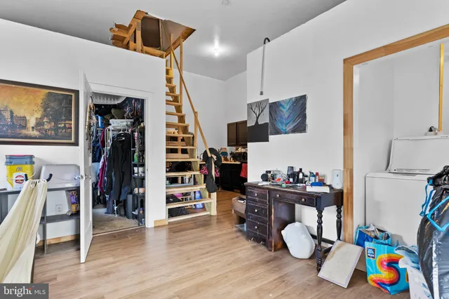 a view of a workspace with furniture and wooden floor