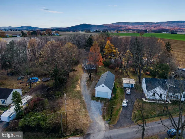 an aerial view of a house with garden space and outdoor seating