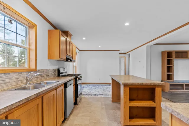 a kitchen that has a sink and a stove in it