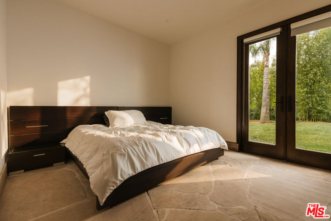 1105 Rivas Canyon Road Pacific Palisades, CA 90272 - Photo 48 of 49 a bedroom with a bed and large window
