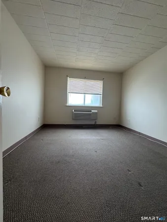 an empty room with a empty space and windows