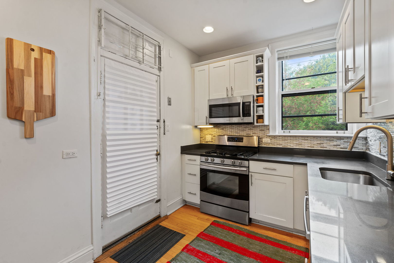 548 Sheridan Road, Unit 2N Evanston, IL 60202 - Photo 10 of 18 a kitchen with stainless steel appliances a stove a sink and a microwave