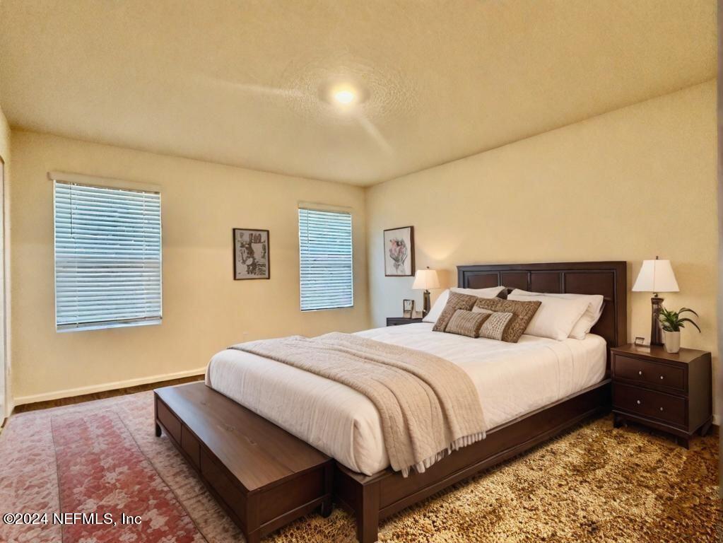 875 Capitol Parkway Jacksonville, FL 32218 - Photo 11 of 20 a bedroom with a bed and a night stand
