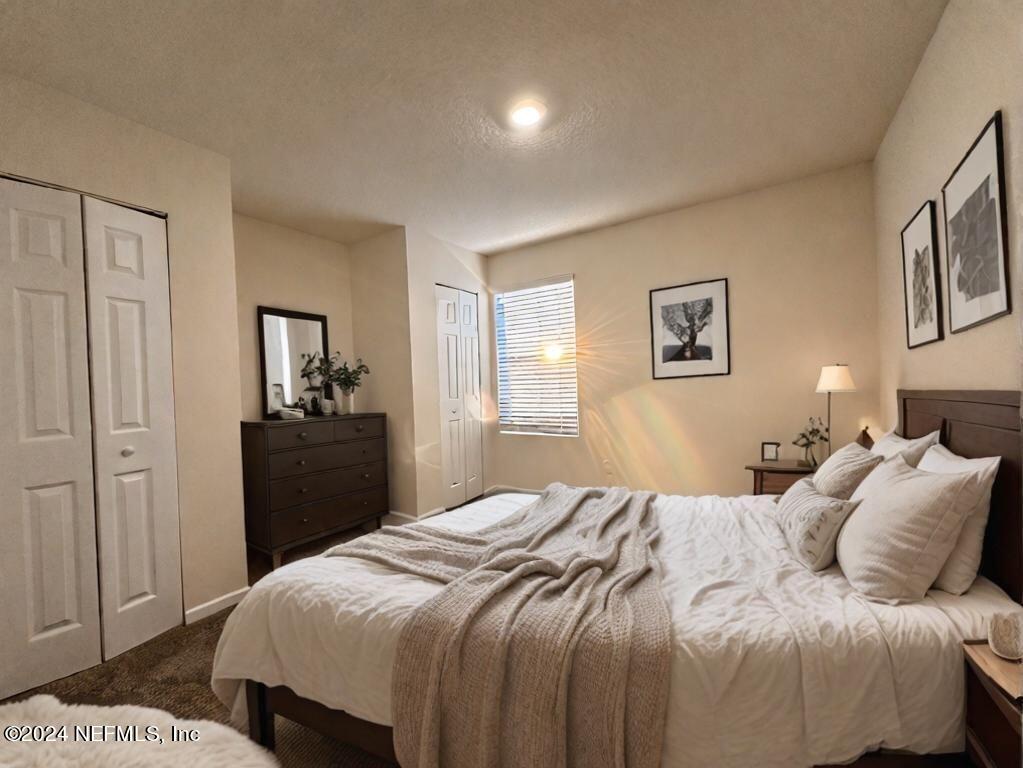 875 Capitol Parkway Jacksonville, FL 32218 - Photo 12 of 20 a bedroom with a bed and a painting on the wall