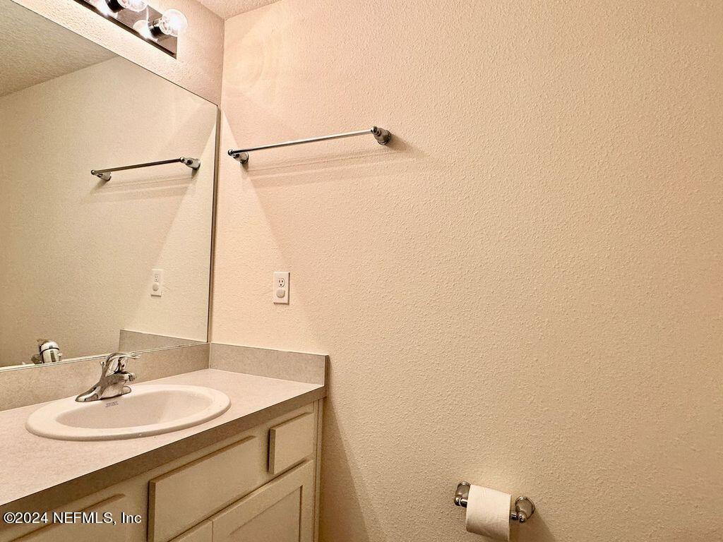 875 Capitol Parkway Jacksonville, FL 32218 - Photo 14 of 20 a bathroom with a sink and a mirror