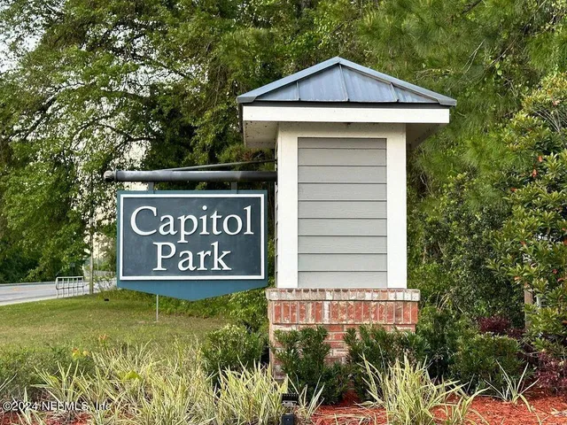 a view of a sign of a park next to a road