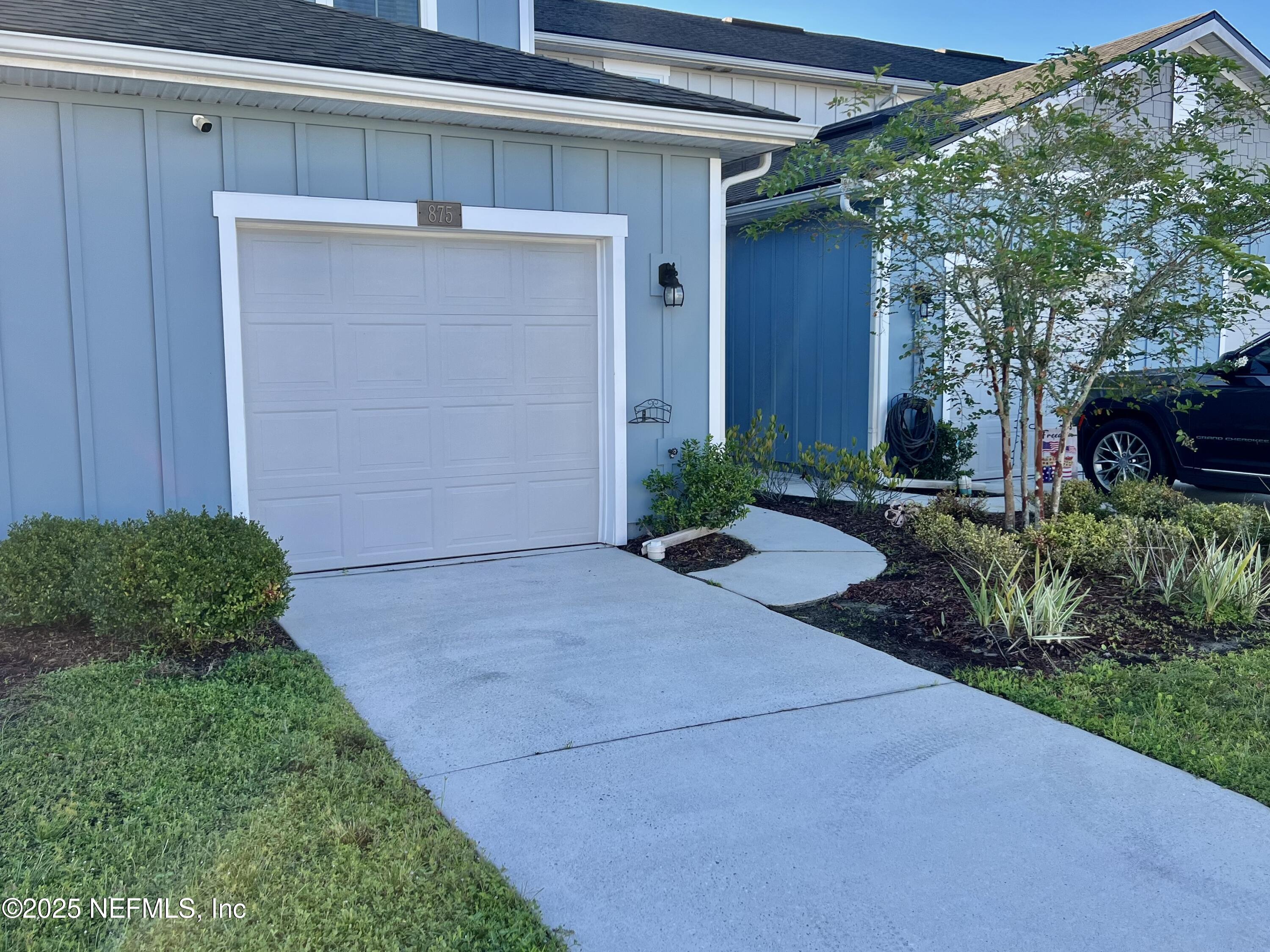 875 Capitol Parkway Jacksonville, FL 32218 - Photo 3 of 20 a backyard of a house with plants and outdoor seating