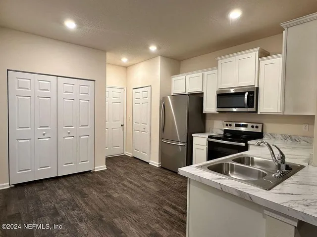 a kitchen with a refrigerator sink and microwave