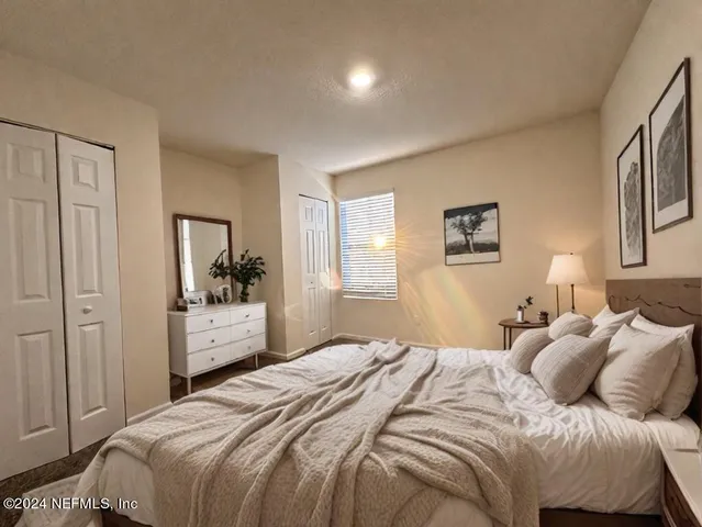 a bedroom with a bed and a mirror