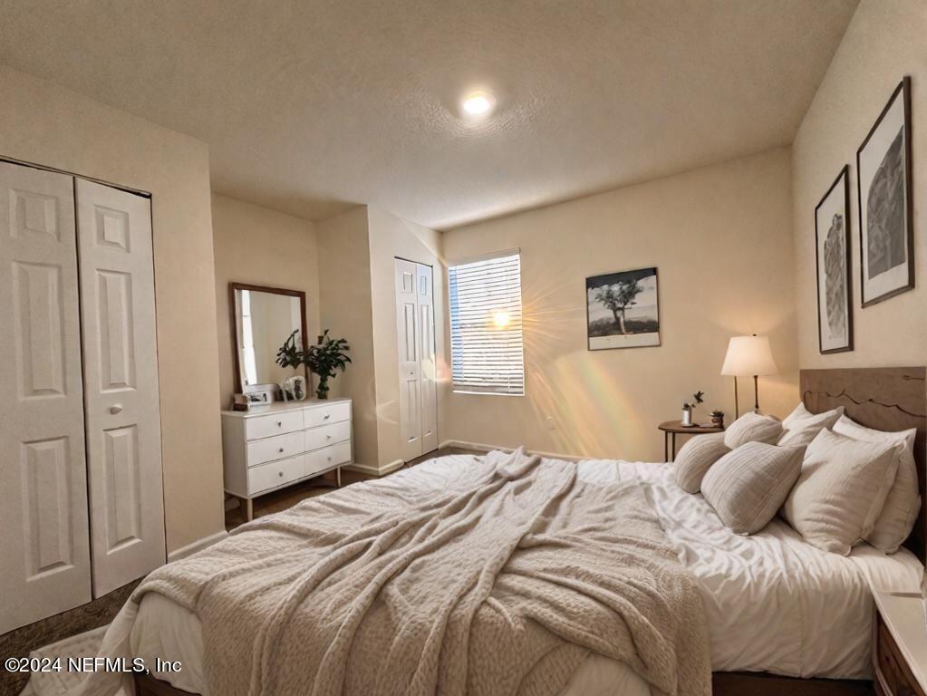 875 Capitol Parkway Jacksonville, FL 32218 - Photo 8 of 20 a bedroom with a bed and a mirror