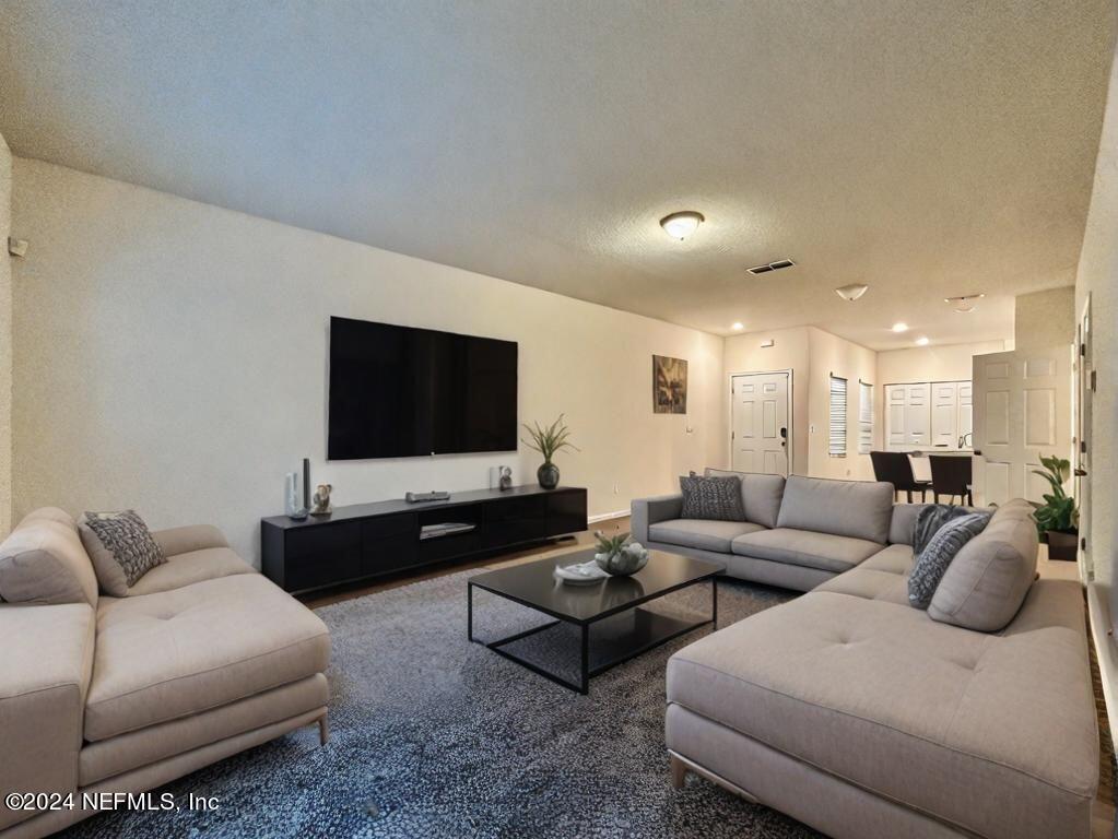 875 Capitol Parkway Jacksonville, FL 32218 - Photo 9 of 20 a living room with furniture and a flat screen tv