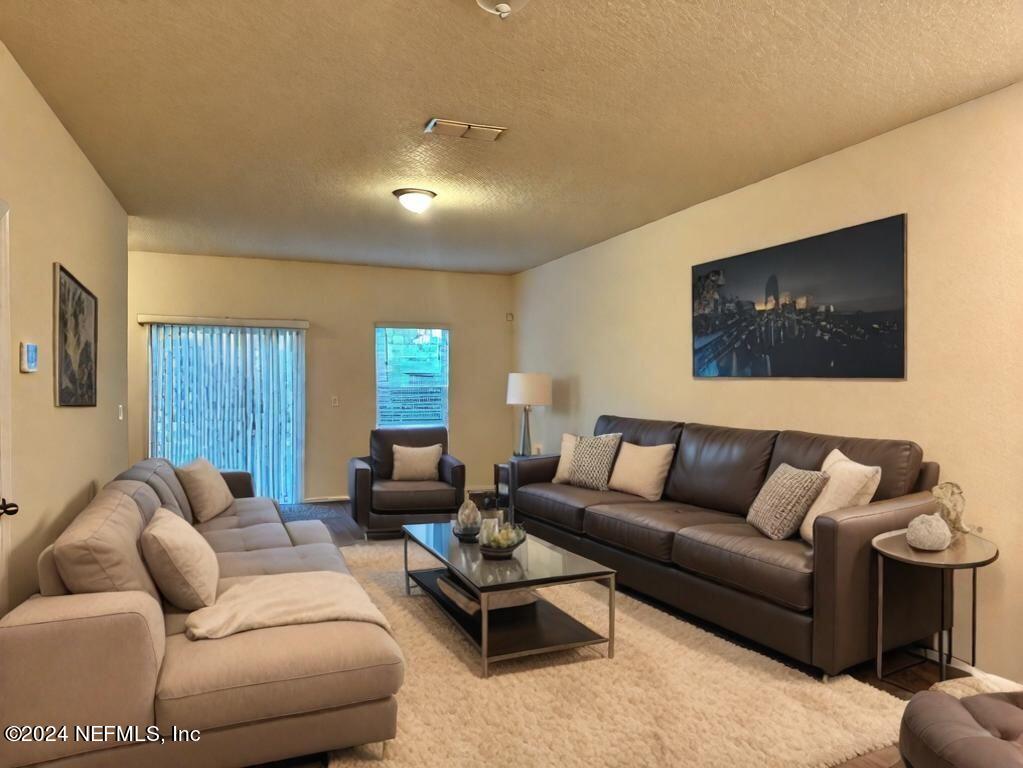 875 Capitol Parkway Jacksonville, FL 32218 - Photo 10 of 20 a living room with furniture and a flat screen tv