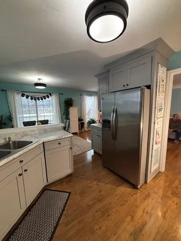 a kitchen with sink cabinets and refrigerator