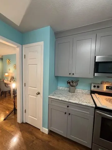 a kitchen with a sink cabinets and a stove