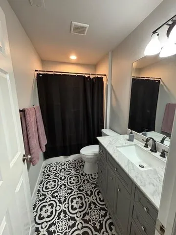 a bathroom with a double vanity sink and mirror