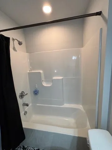 a bathroom with a shower and a toilet