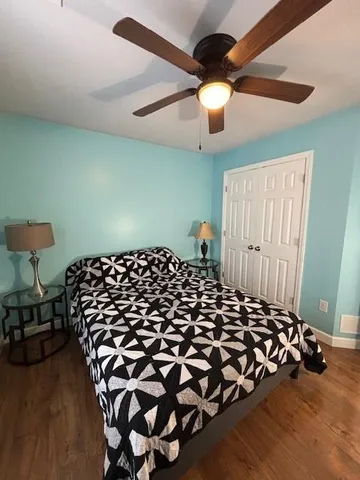 a bedroom with a bed and a chandelier