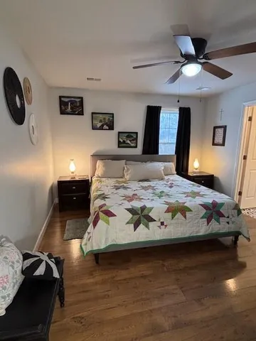 a bedroom with a bed and a chandelier