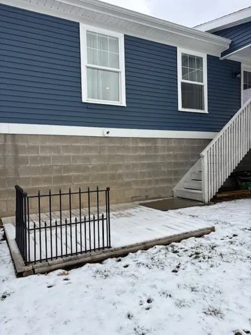 a view of a brick house with wooden fence