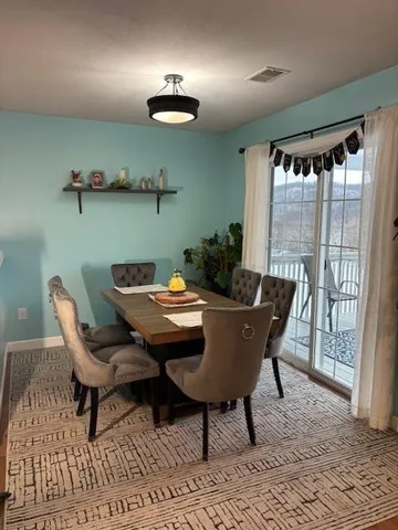 a view of a dining room with furniture window and outside view