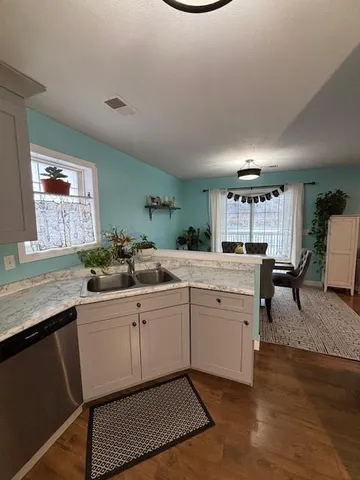 a open kitchen with a sink and cabinets