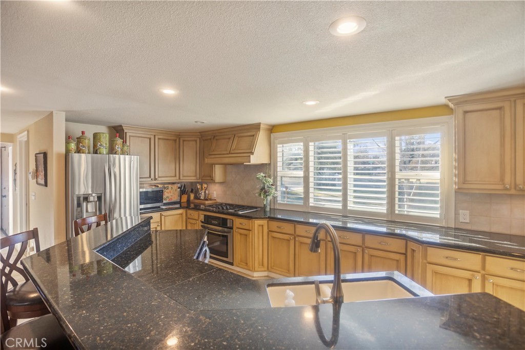 2858 Forist Lane Merced, CA 95340 - Photo 21 of 57 a living room with stainless steel appliances granite countertop a sink and a refrigerator