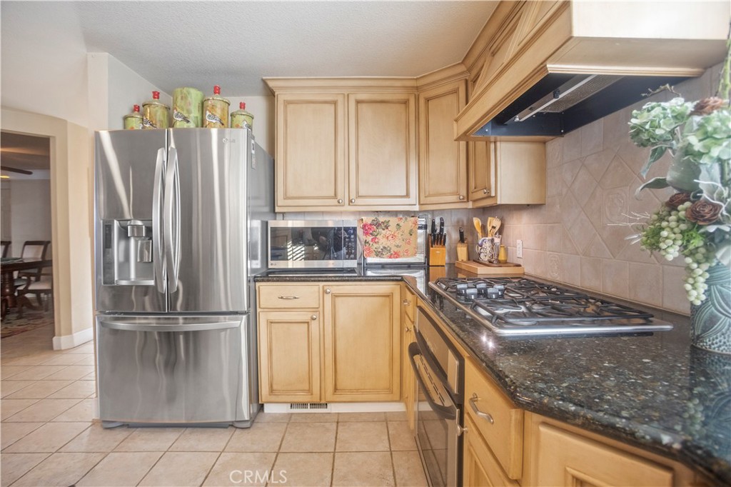 2858 Forist Lane Merced, CA 95340 - Photo 22 of 57 a kitchen with stainless steel appliances granite countertop a refrigerator and a stove