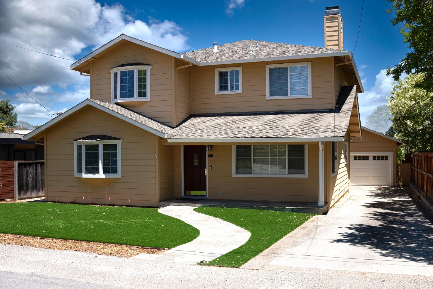 a front view of a house with a yard