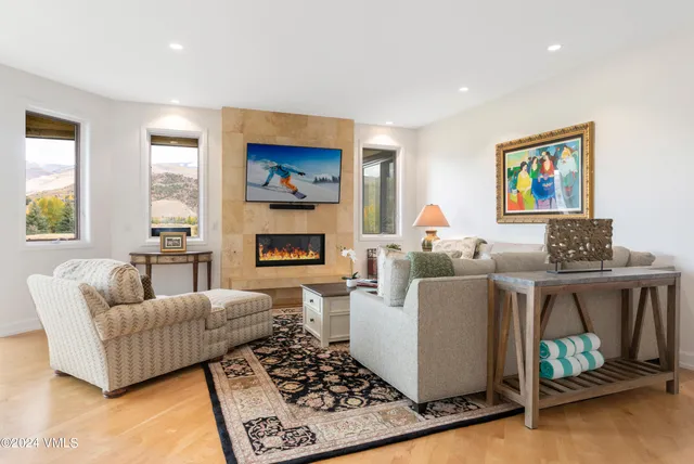 a living room with furniture and a fireplace