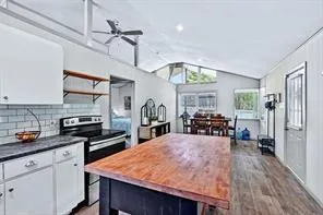 a kitchen with stainless steel appliances granite countertop sink stove refrigerator and cabinets