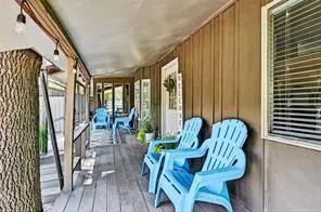 a view of balcony with furniture and wooden floor