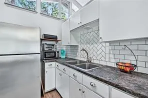 a kitchen with stainless steel appliances granite countertop a sink and a granite counter tops