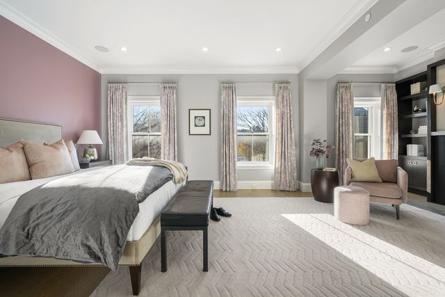 a bedroom with a balcony a bed and a flat screen tv