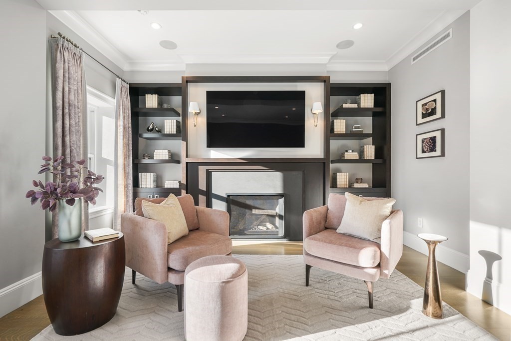 75 Beacon Street, Unit 2 Boston, MA 02108 - Photo 28 of 37 a living room with furniture a flat screen tv and a fireplace