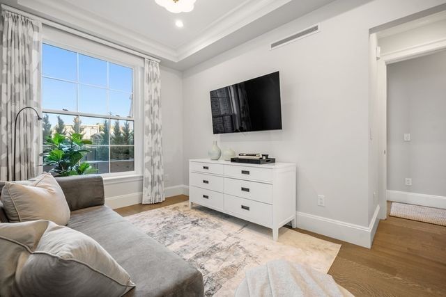 a bedroom with a large bed and a potted plant