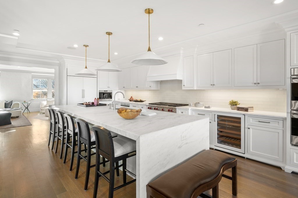 75 Beacon Street, Unit 2 Boston, MA 02108 - Photo 7 of 37 a kitchen with a dining table chairs sink and cabinets