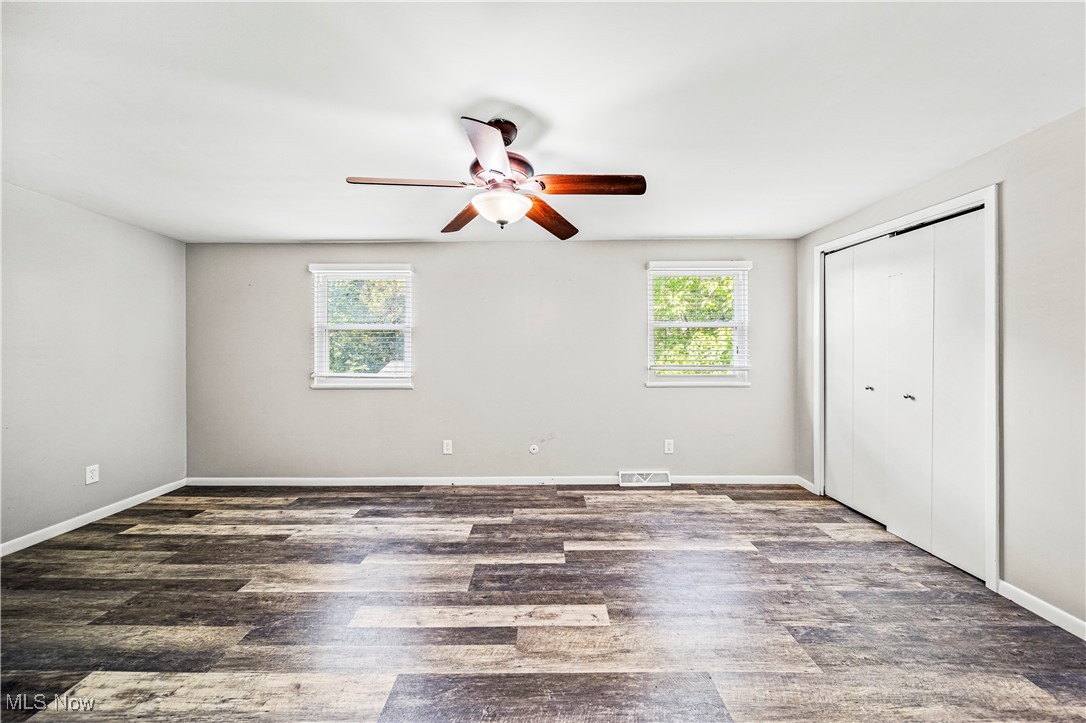 1796 Lander Road Mayfield Heights, OH 44124 - Photo 27 of 39 Unfurnished bedroom featuring multiple windows, dark wood-type flooring, ceiling fan, and a closet