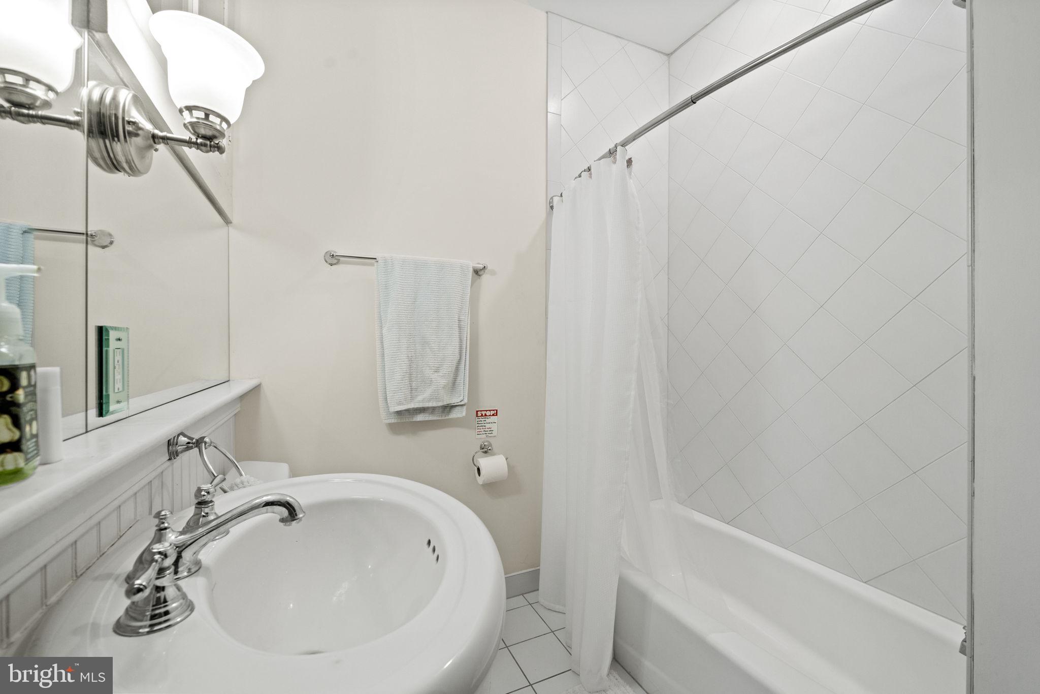 415 William Street, Unit A Fredericksburg, VA 22401 - Photo 12 of 17 a bathroom with a sink a toilet and shower
