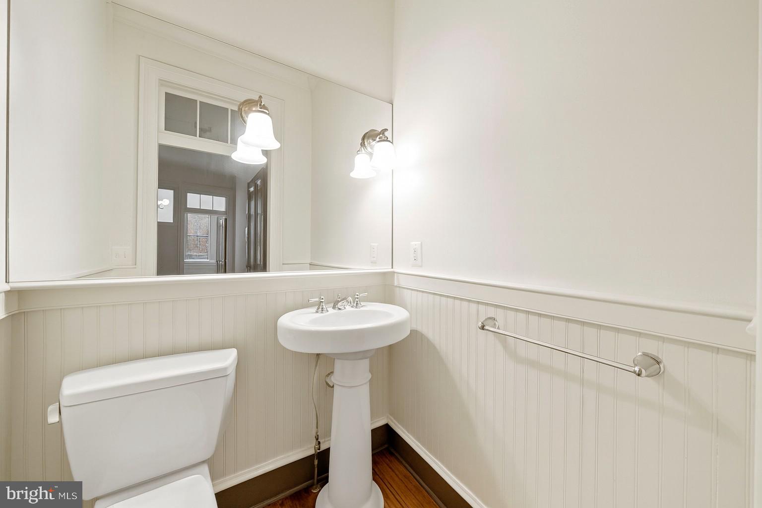 415 William Street, Unit A Fredericksburg, VA 22401 - Photo 6 of 17 a bathroom with a sink a toilet and mirror