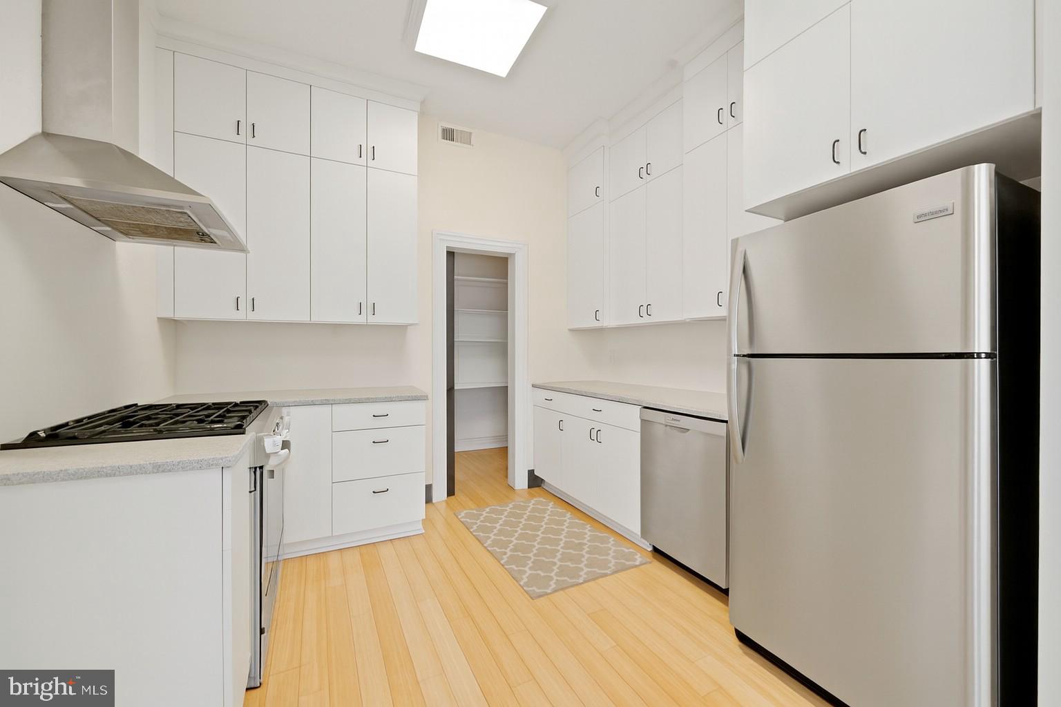 415 William Street, Unit A Fredericksburg, VA 22401 - Photo 7 of 17 a kitchen with stainless steel appliances a refrigerator sink and cabinets