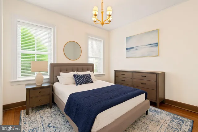 a bedroom with a bed mirror and a window