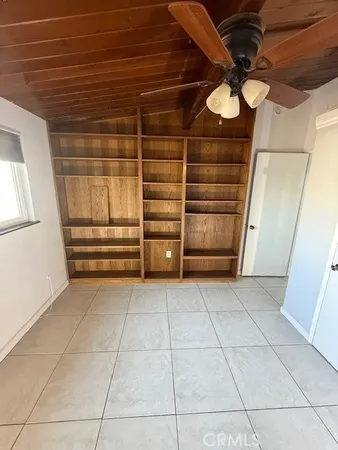 a view of an empty room with closet
