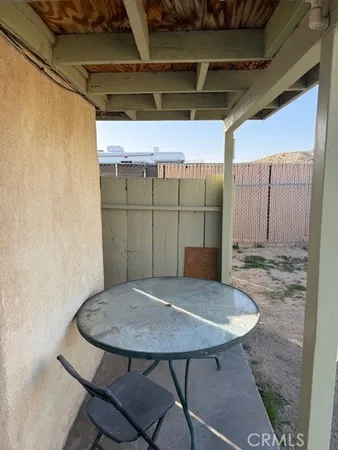 a view of a balcony with a table and chairs