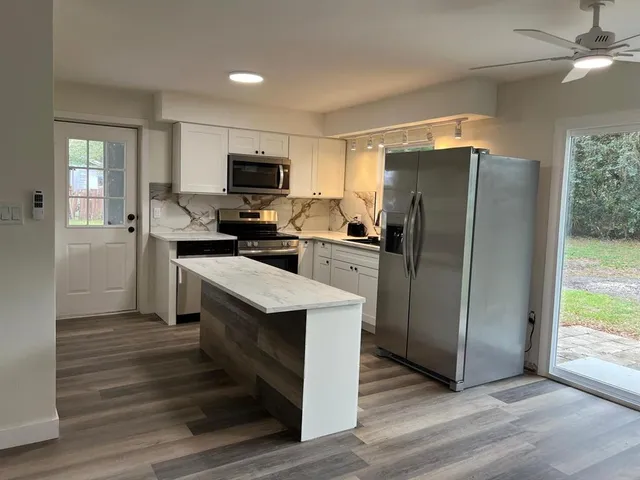 a kitchen with stainless steel appliances a refrigerator stove and sink
