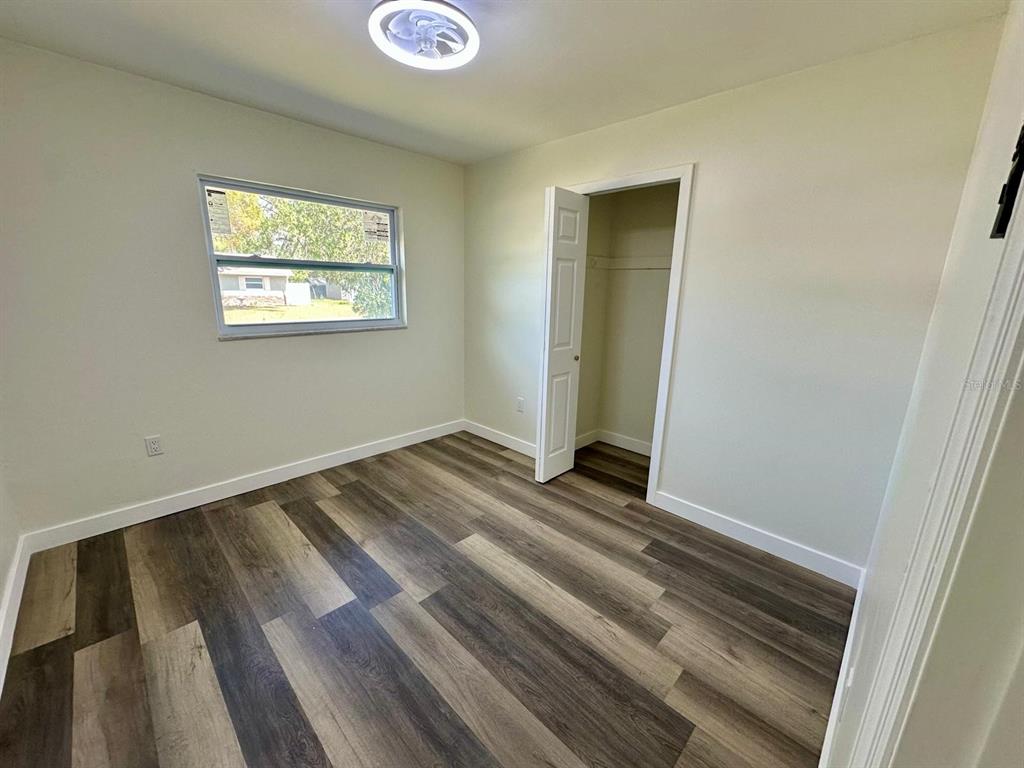 1812 Northeast 50th Street Ocala, FL 34479 - Photo 7 of 15 a view of a room with wooden floor and window