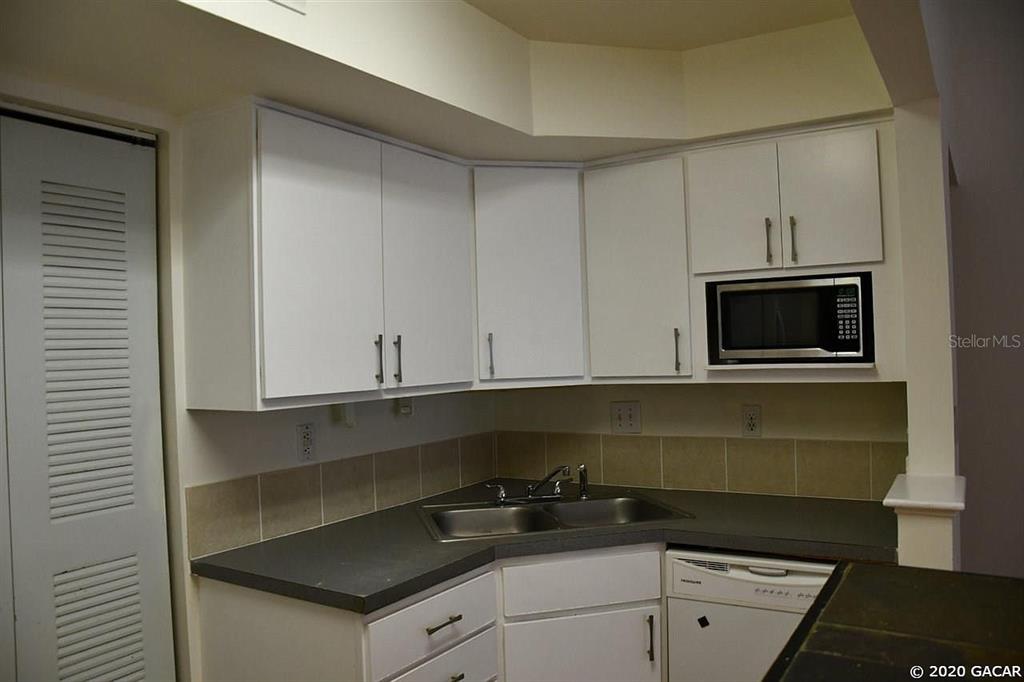 2601 Southwest Archer Road, Unit 321 Gainesville, FL 32608 - Photo 4 of 10 a kitchen with a sink and cabinets